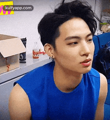 a close up of a person wearing a blue tank top .