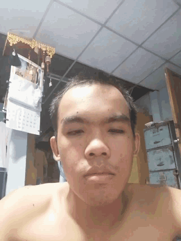 a man without a shirt is taking a picture of himself in front of a calendar that shows the month of january