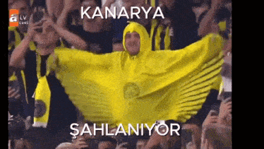 a man in a yellow cape with the word kanarya on the bottom
