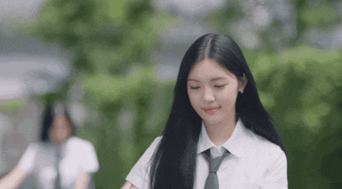 a girl with long black hair and a white shirt and tie