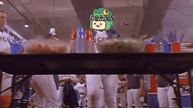 a group of people are gathered around a table with a frog on top of it
