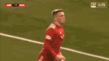 a group of soccer players celebrate a goal against iran