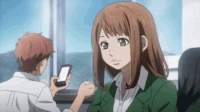 a girl with brown hair is looking at a phone