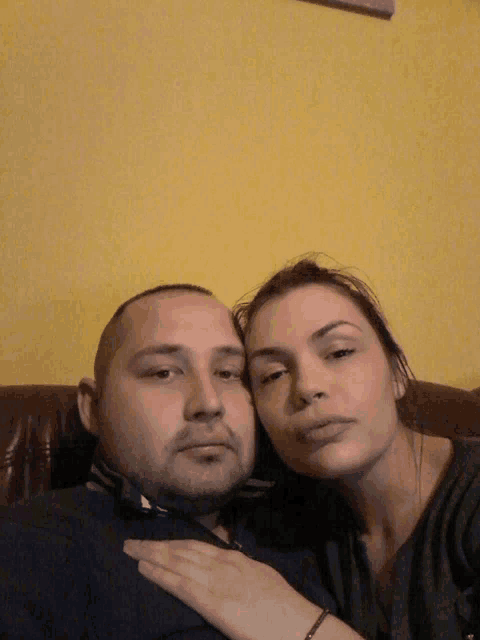 a man and a woman are posing for a photo