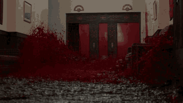 a room with a red door and a lot of blood coming out of it