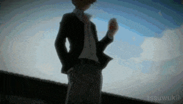 a man in a suit is standing in front of a cloudy sky with tssuwukii written on the bottom