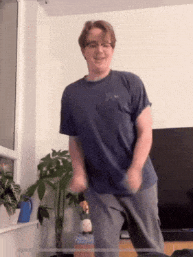 a man in a blue nike shirt is dancing