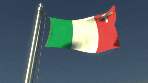 a green white and red flag with a cross on it is waving in the wind