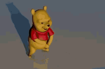 winnie the pooh is wearing a red shirt and dancing on a blue background .
