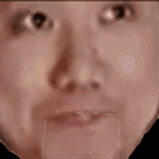 a close up of a person 's face with a red circle in his mouth