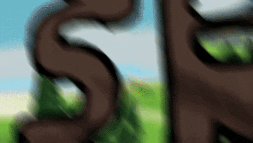 a blurry picture of the letter s in a field with trees in the background
