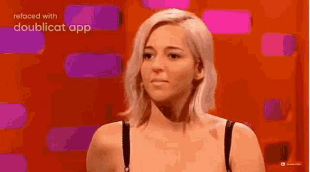 a woman in a bra is giving the middle finger to the camera .