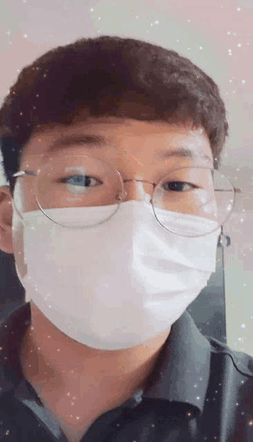 a man wearing glasses and a face mask