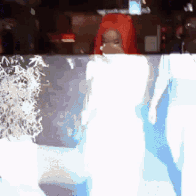 a blurred image of a person in a red wig