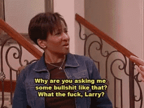 a woman in a denim jacket is sitting on a staircase talking to a man in a wrought iron railing .