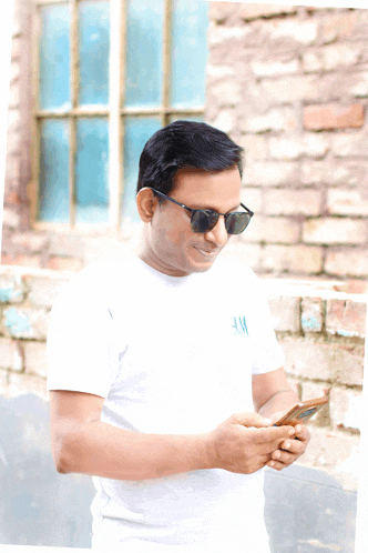 a man wearing sunglasses and a white shirt that says hm