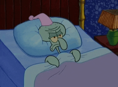 squidward from spongebob squarepants is laying in bed wearing a nightcap and a hat .