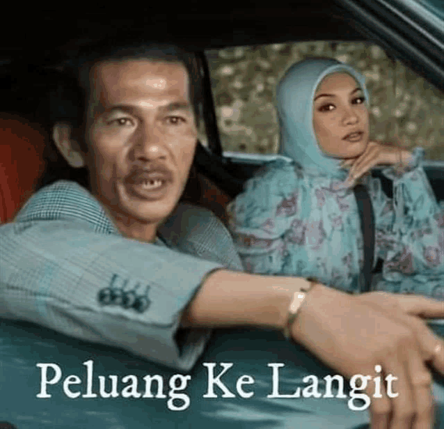 a man and a woman are sitting in a car and the man is talking to the woman .