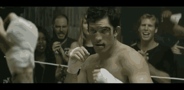a man in a boxing ring with his hands wrapped in bandages .