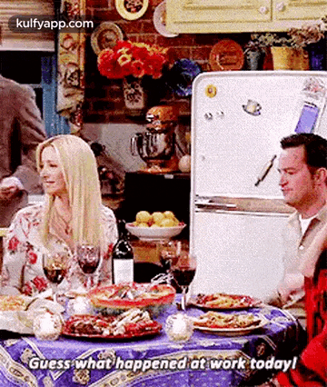 a group of people are sitting at a table with plates of food .