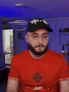 a man with a beard wearing a red shirt that says joblife