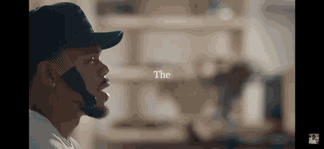 a man wearing a hat with the word " the " above him