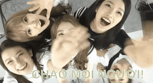 a group of young women are sitting in a circle and making a funny face .