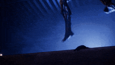 a silhouette of a person is hanging from the ceiling