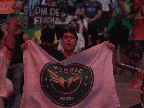 a man holds up a flag that says herdic on it