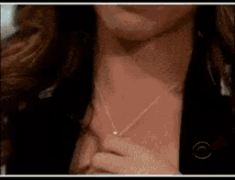 a close up of a woman 's neck with a necklace on it