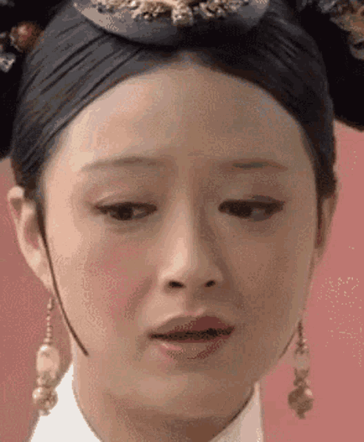 a close up of a woman 's face with a very sad look on her face