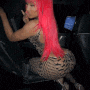a woman with red hair is sitting in the back of a car .