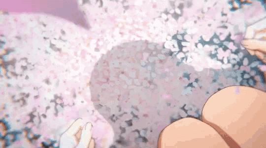 a person is sitting on the ground with their hands in the air .
