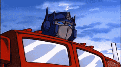 a cartoon of optimus prime looking out the window of a truck