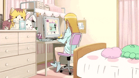 a girl is sitting at a desk in front of a computer in a bedroom
