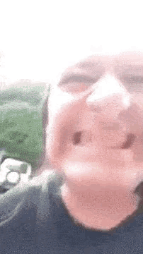a close up of a person 's face with a blurred background