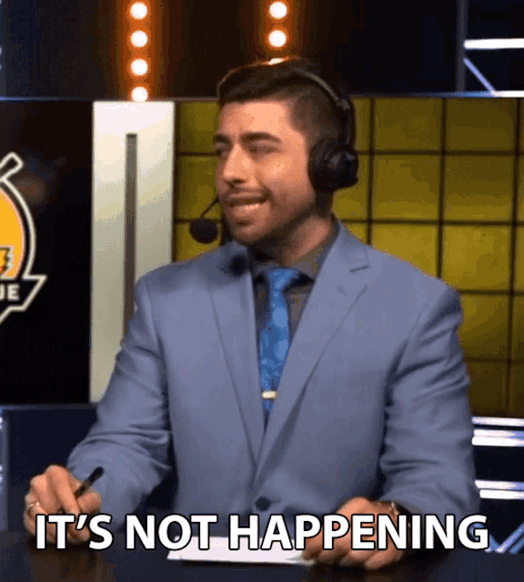 a man in a suit and tie says it 's not happening while wearing a headset