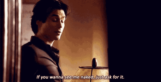 a man is standing in front of a lamp and talking to someone .