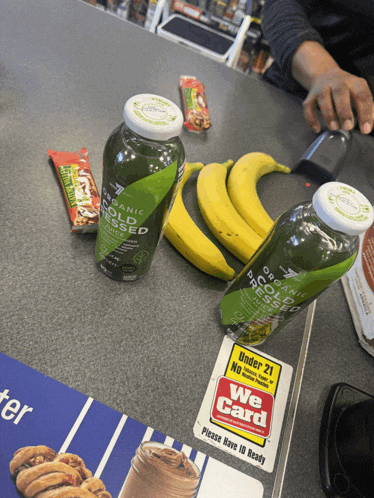 two bottles of organic cold pressed juice and bananas