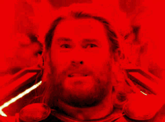 a man with a beard and long hair is making a funny face
