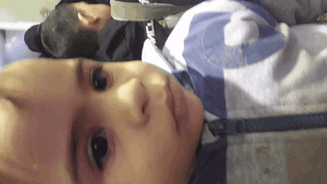 a close up of a baby 's face with the number 6 on his sweatshirt