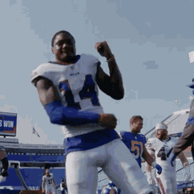 a football player with the number 51 on his jersey is dancing