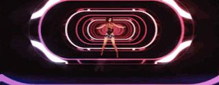 a woman in a wonder woman costume is dancing in front of a circle of lights