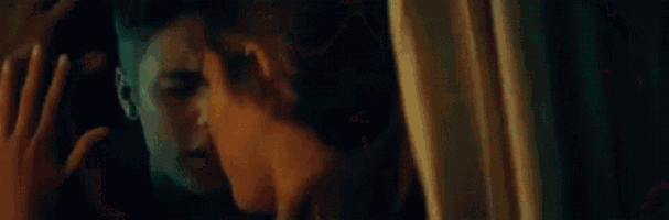 a man and a woman are looking at each other in the mirror .