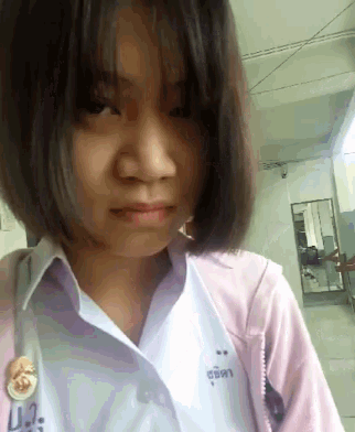 a girl wearing a white shirt and a pink jacket with ua on it