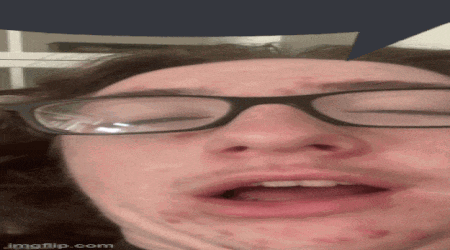 a close up of a person wearing glasses with a speech bubble above their head