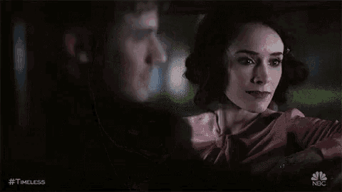 a man and woman are looking at each other in a car at night .