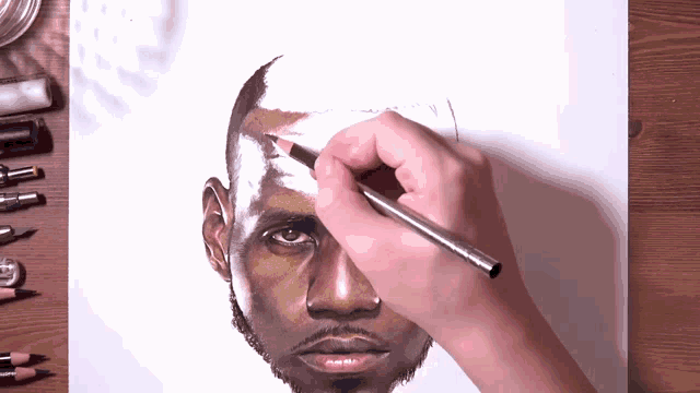 a person drawing a man 's face with a pencil