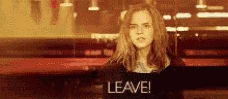 a woman is standing in front of a window with the words `` leave '' on it .