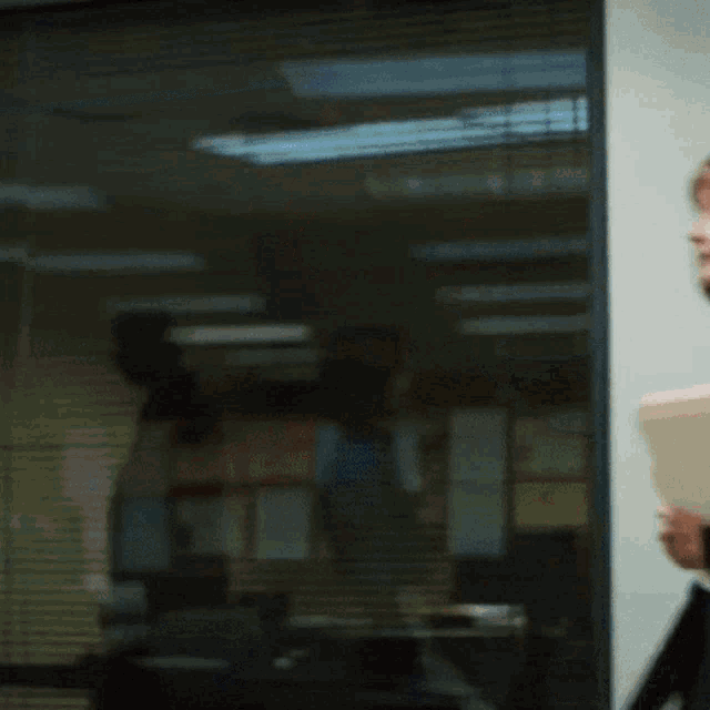a blurry picture of a woman holding a binder